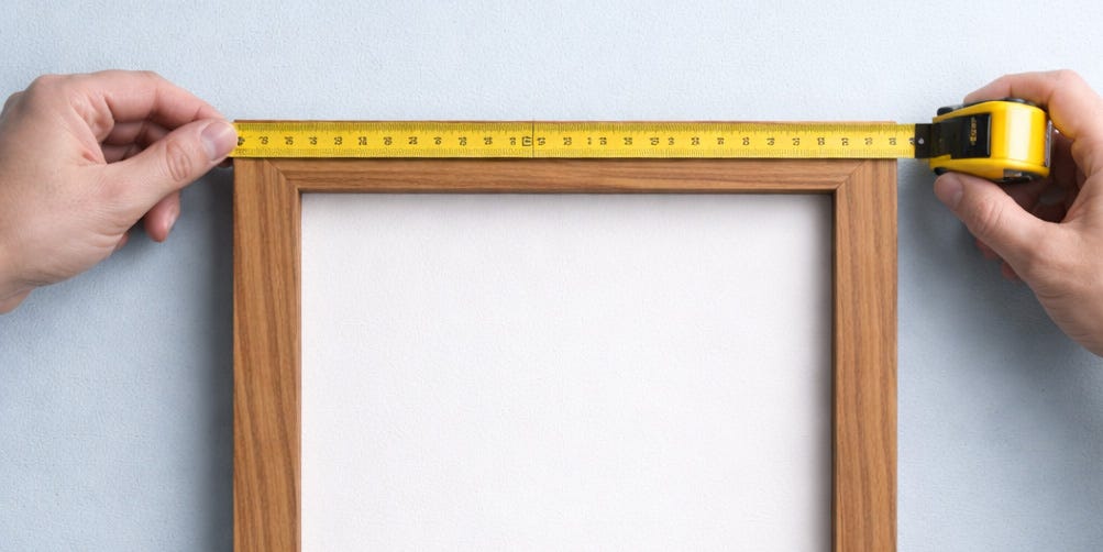 Measuring a wooden frame for a canvas print