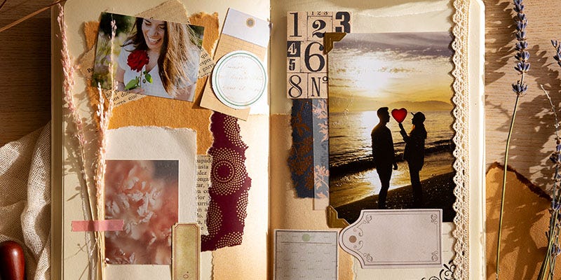 Collage-style scrapbook with many images and pieces of artistic paper stuck on, with dried flowers. There is a photo of a couple standing on a beach at sunset.