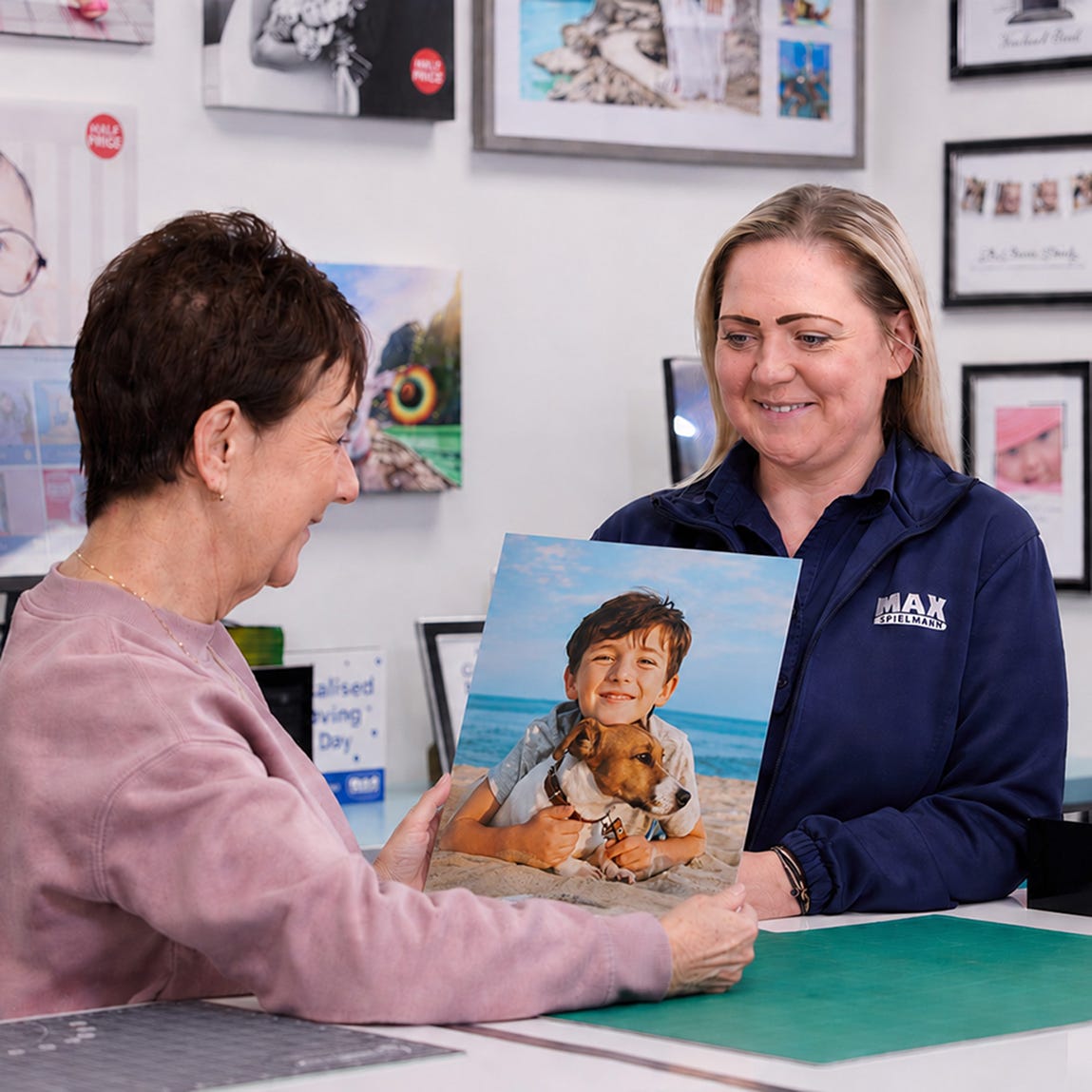holding a poster print in a max spielmann shop