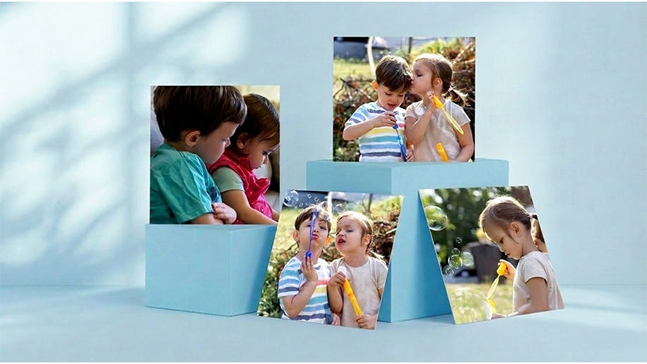 holding square photo prints