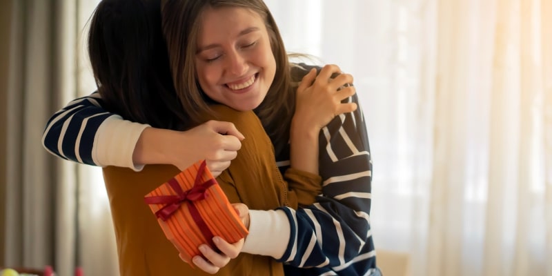 people hugging after receiving a great gift