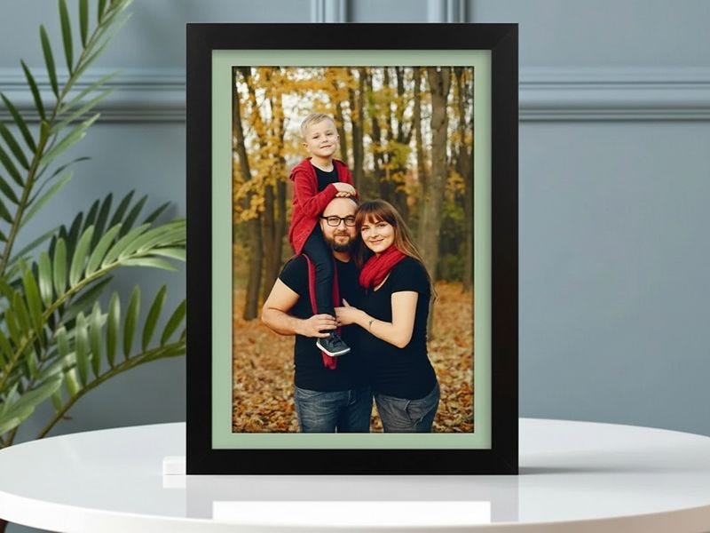 black and green framed photo print of a family of three