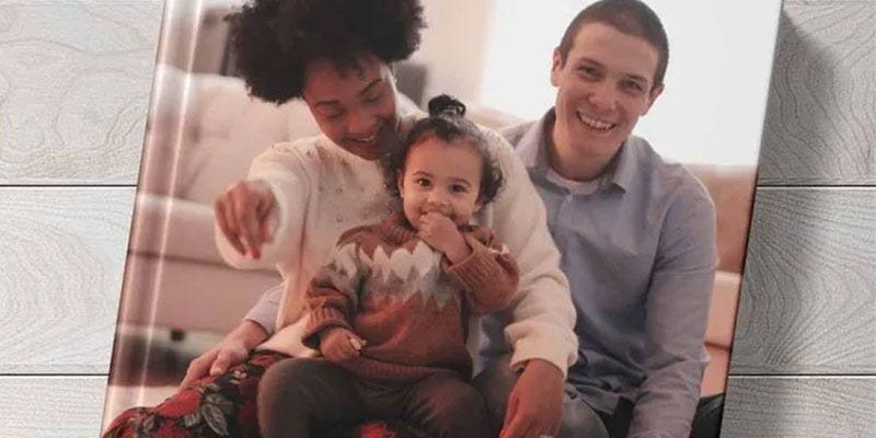 Hardcover Photo Book with a photograph of a Mother, Father and daughter smiling.
