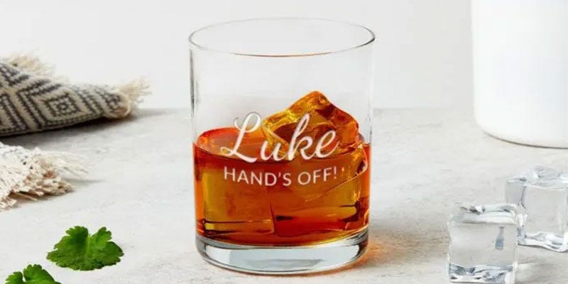 Personalised glass engraved with 'Luke Hands OFF'