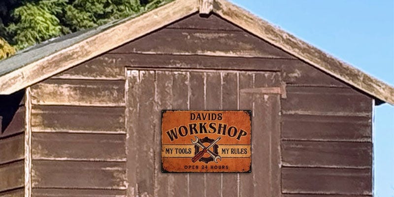 Personalised metal board designed as a personalised Father's Day gift, hung on a shed.