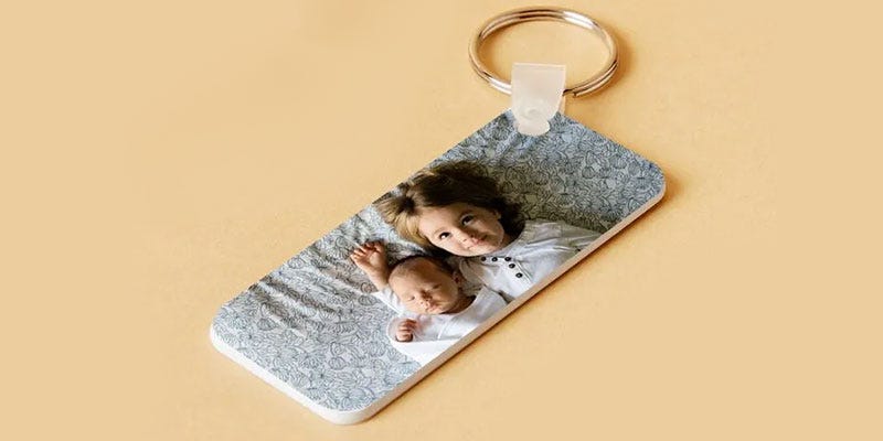 Photo of two young children printed onto a rectangular photo keyring.