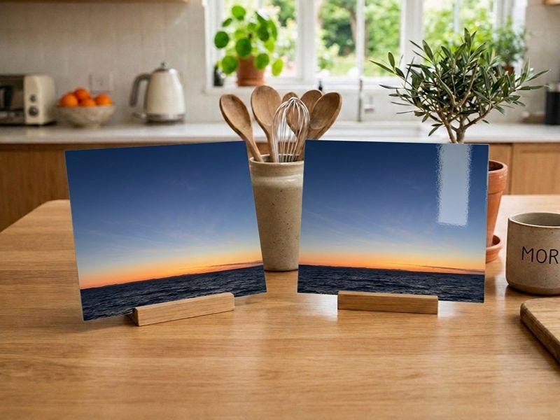 a glossy photo print next to a matt photo print on a table in a modern kitchen