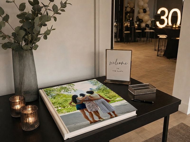 photo book gift displayed on a welcome table at a 30th birthday party